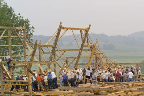 A group of Amish farmers raises a barn